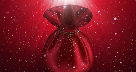 Red christmas sack with falling snow and sparkling lights