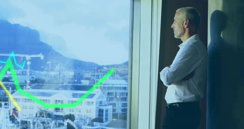 Businessman Analyzing Graphs in Modern Office Setting