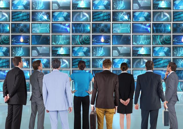 Digital composition of group of businesspeople looking at display on screen