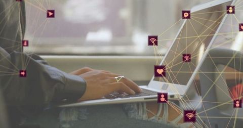 Woman telecommuting on train with laptop amid digital icons