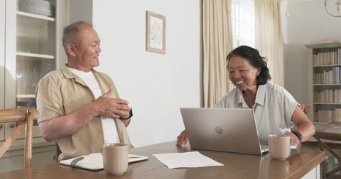 Senior couple planning use technology at home with joyful attitude