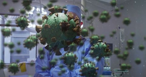 Surgeon standing in operating room wearing scrubs surrounded by floating coronavirus visuals
