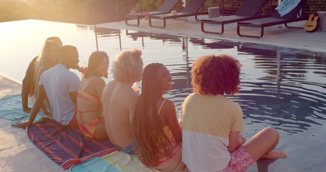 Diverse Group of Friends Sitting by Pool at Sunset - Download Free Stock Images Pikwizard.com