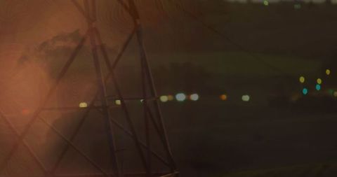 Windmill Silhouette at Sunset with Twinkling City Lights