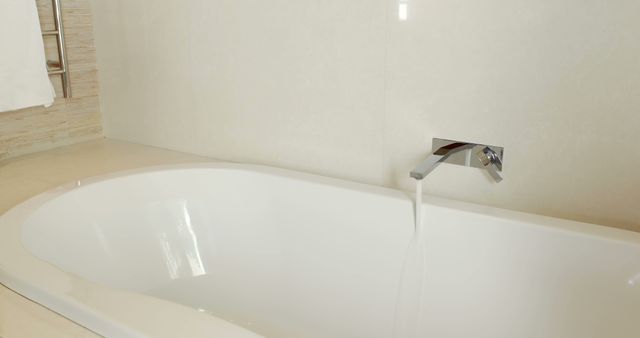 Modern White Bathtub with Flowing Water in Minimalist Bathroom - Download Free Stock Images Pikwizard.com