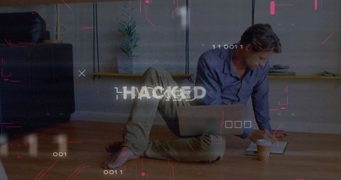 Man Using Laptop in Informal Setting Surrounded by Hacked Alert Graphics
