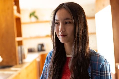 Young Woman in Cozy Rustic Kitchen with Warm Light