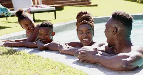 Joyful african american family enjoying poolside togetherness