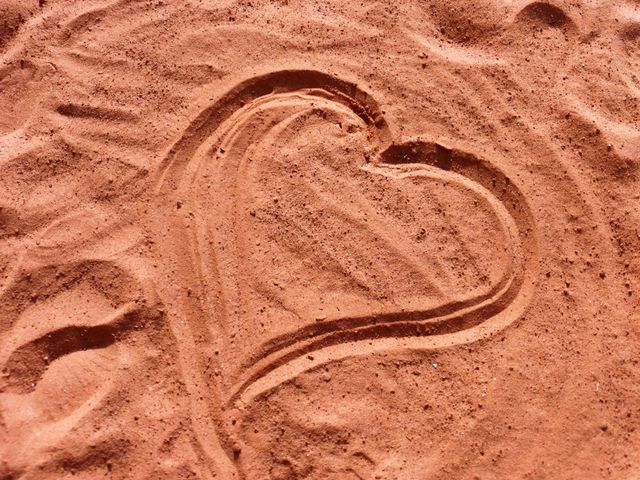 close up view of heart shape drawn in a sand.  love and valentine's day concept