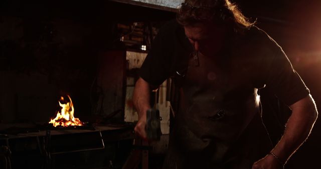 Blacksmith Shaping Metal with Hammer, Workshop Background Enigmatic Lighting - Download Free Stock Images Pikwizard.com