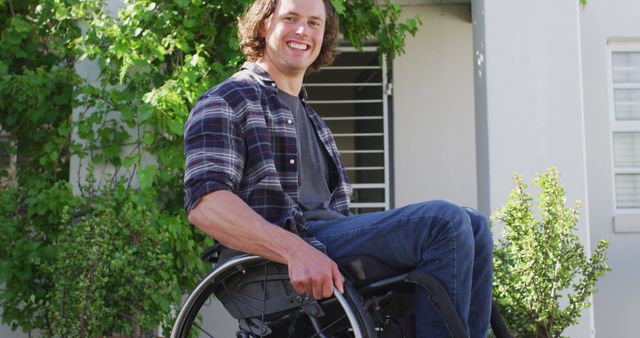 Smiling man in wheelchair outdoors near home - Download Free Stock Images Pikwizard.com