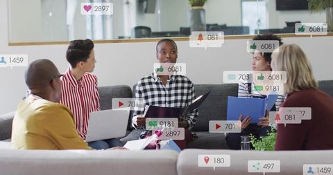 Leading team discussion and presenting strategy in modern office lounge with social media icons