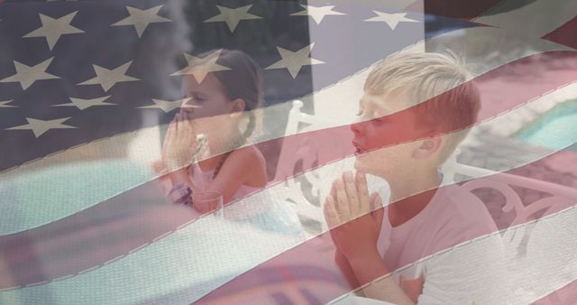 Children holding hands and praying, with an overlay of the American flag representing themes of faith and national pride. This image is great for use in content related to patriotism, spirituality, and unity in the USA. Suitable for illustrating national holidays like Independence Day, Memorial Day, and religious events.