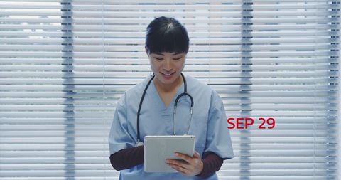 Healthcare Professional Using Digital Tablet in Clinical Environment