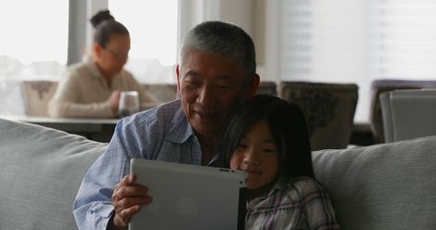 Grandfather and Granddaughter Using Tablet at Home - Download Free Stock Images Pikwizard.com
