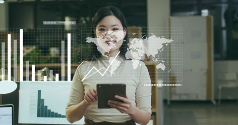 Female data analyst reviewing interactive digital charts in modern office