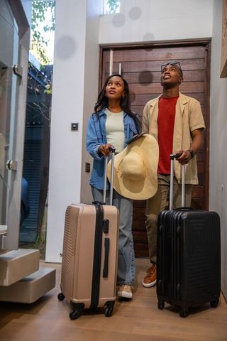 Couple Arriving Home with Luggage, Embarking on New Adventure