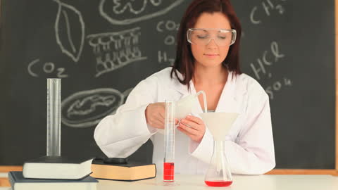 Female Scientist Conducting Lab Experiment with Beaker and Funnel