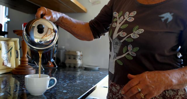 Senior Woman Pouring Coffee in Kitchen - Download Free Stock Images Pikwizard.com