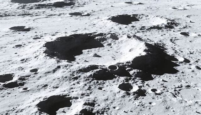 Lunar impact crater with terraced rim, stepped regolith and scattered boulders
