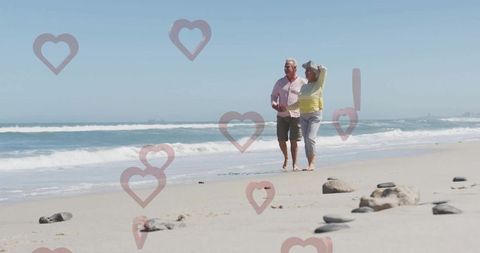 Senior Couple Enjoying Walk on Oceanside Shores with Love Overlay
