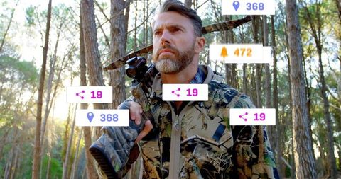 Holding scoped crossbow, mature outdoorsman in camo with ar overlay in pine forest