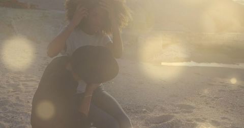 Young Couple Enjoying Beach Reverie Under Golden Sunset