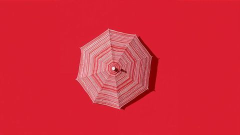 Vibrant red and white striped parasol with bold design
