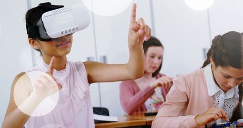 Teen girl exploring virtual reality while classmates building electronics and learning stem
