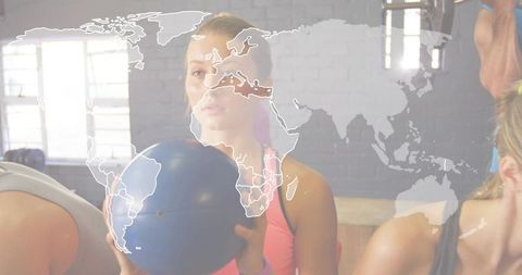Global fitness concept woman holding medicine ball group training with world map overlay