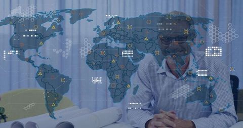 Executive analyzing global network data overlay with world map and blueprints