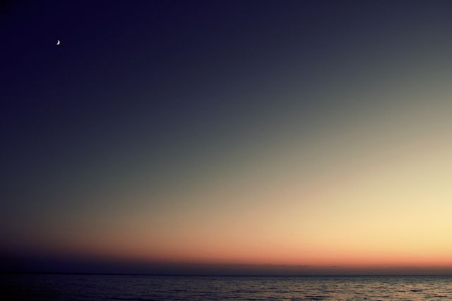 Tranquil Sunset Over Ocean With Moonlit Sky - Download Free Stock Photos Pikwizard.com