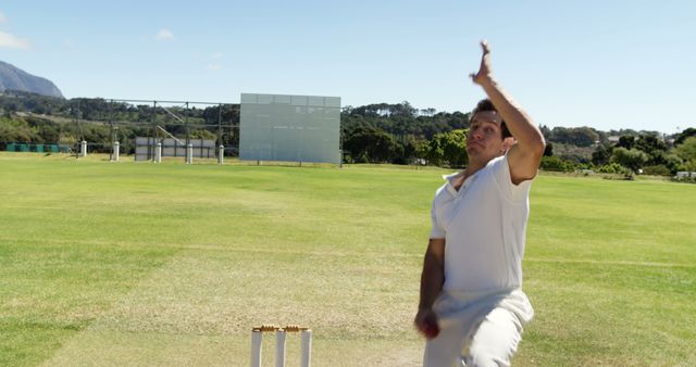 Cricket Bowler Delivering Ball on Field Under Bright Sky - Download Free Stock Images Pikwizard.com