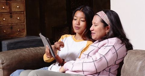Mother Daughter Technology Bonding on Cozy Living Room Sofa