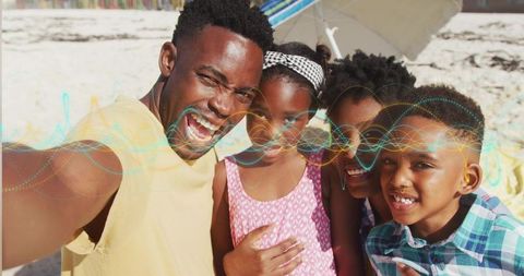 Smiling Black Family Posing for Beach Selfie Under Umbrella on Sunny Sand Vacation