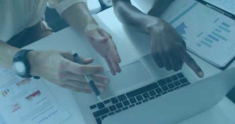 Colleagues Analyzing Data on Laptop with Financial Charts