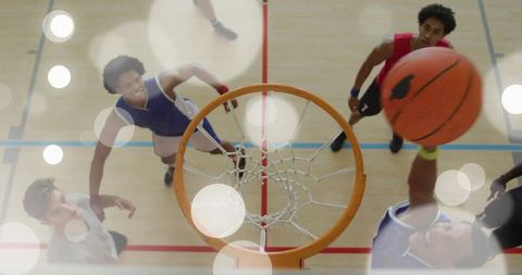Dynamic Dunking Young Male Athletes Competing in Intense Basketball Game