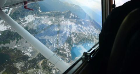 Aerial View from Aircraft Window Over Mountainous Lakes Area