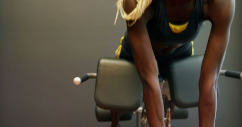 Athletic Woman Using Gym Equipment During Workout