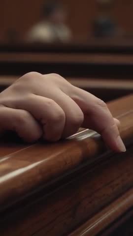 Hand Tracing Wooden Bench Rail in Courtroom Vertical Video, Closeup Finger During Hearing