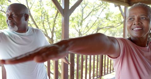 Senior African American Couple Practicing Yoga Outdoors