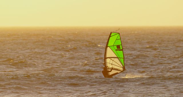 Windsurfer Gliding Across Ocean with Golden Sunset - Download Free Stock Images Pikwizard.com