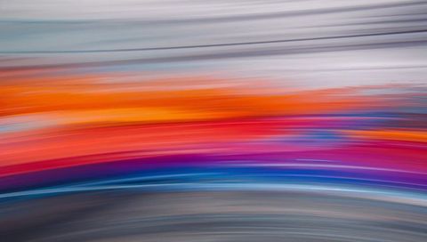 Vibrant horizontal motion blur gradient with orange purple and blue streaks