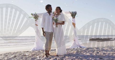 Romantic Beach Wedding with Bride and Groom Under Floral Arch