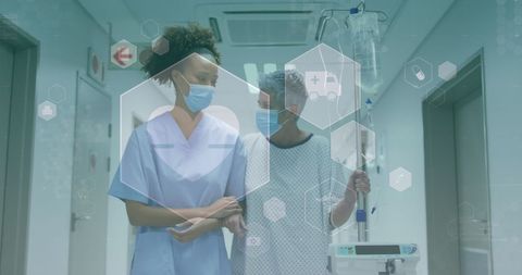 Doctor Assisting Patient with Infusion in Hospital Corridor