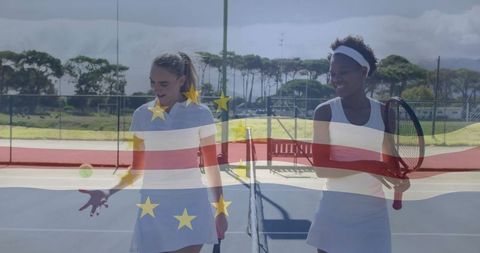 Female tennis players practicing on outdoor court under bright sky