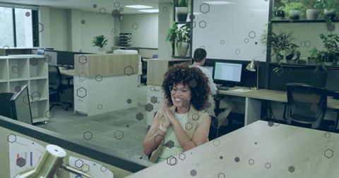 Smiling Woman in Modern Office Being Productive
