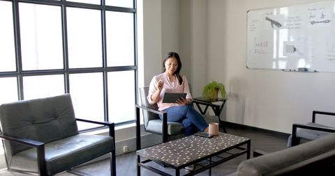 Businesswoman Holding Session Using Tablet in Modern Office