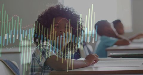 Smiling schoolchild studying with colorful data visualization overlay in modern classroom