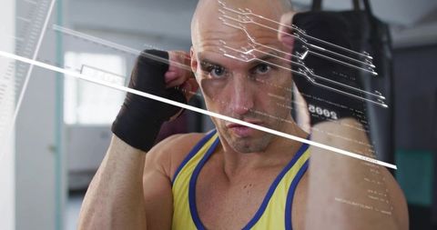 Intense close-up boxer training with hand wraps and heavy bag showing focus and grit